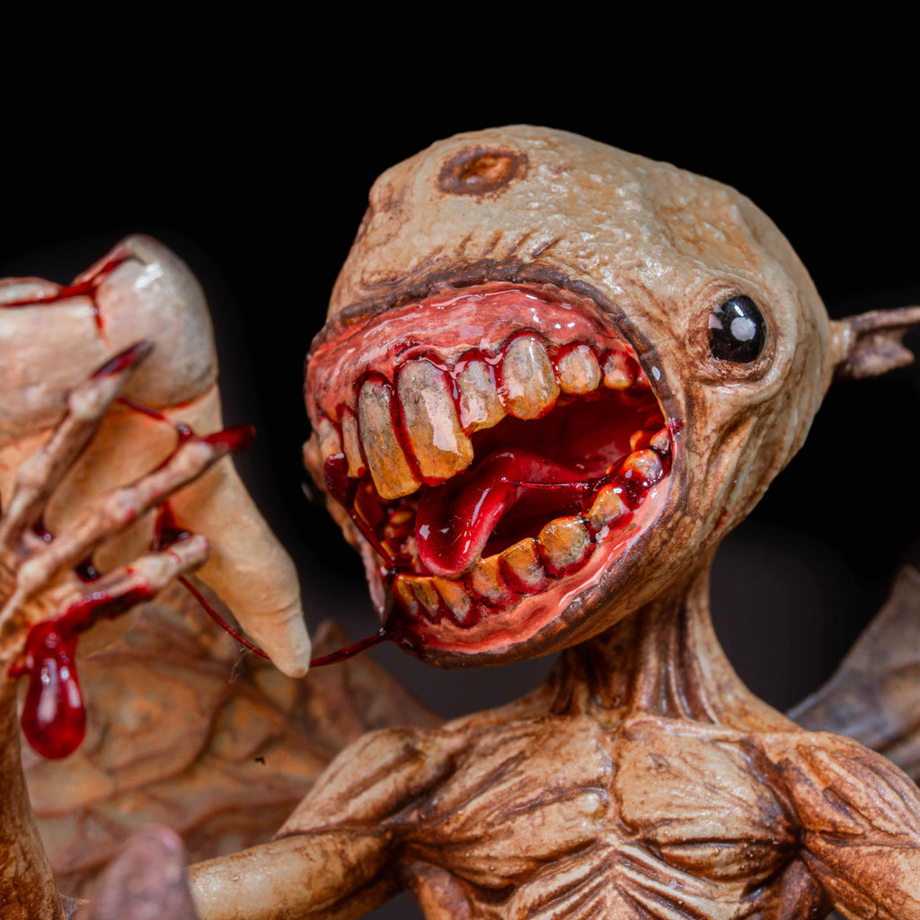 3D printed Tooth Fairy Hellboy figurine with skeletal wings, sharp claws, and a grotesque grin holding a tooth, surrounded by scattered white teeth. Hand-painted in bone, red, and brown tones, this dark fantasy collectible doubles as a tooth holder, making it perfect for gothic decor, horror props, or a unique keepsake for children’s lost teeth.