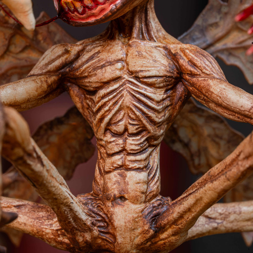 3D printed Tooth Fairy Hellboy figurine with skeletal wings, sharp claws, and a grotesque grin holding a tooth, surrounded by scattered white teeth. Hand-painted in bone, red, and brown tones, this dark fantasy collectible doubles as a tooth holder, making it perfect for gothic decor, horror props, or a unique keepsake for children’s lost teeth.