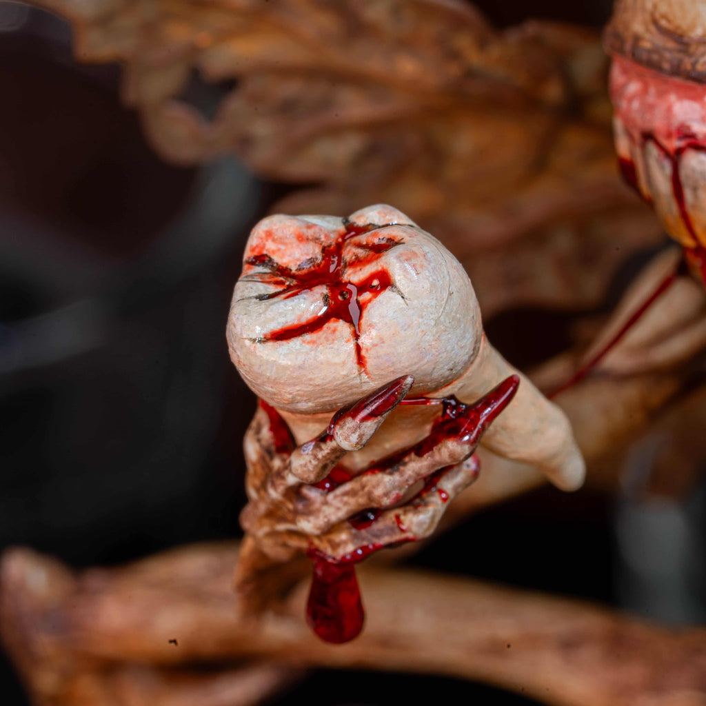 3D printed Tooth Fairy Hellboy figurine with skeletal wings, sharp claws, and a grotesque grin holding a tooth, surrounded by scattered white teeth. Hand-painted in bone, red, and brown tones, this dark fantasy collectible doubles as a tooth holder, making it perfect for gothic decor, horror props, or a unique keepsake for children’s lost teeth.