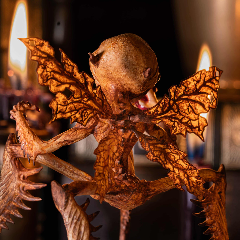 3D printed Tooth Fairy Hellboy figurine with skeletal wings, sharp claws, and a grotesque grin holding a tooth, surrounded by scattered white teeth. Hand-painted in bone, red, and brown tones, this dark fantasy collectible doubles as a tooth holder, making it perfect for gothic decor, horror props, or a unique keepsake for children’s lost teeth.