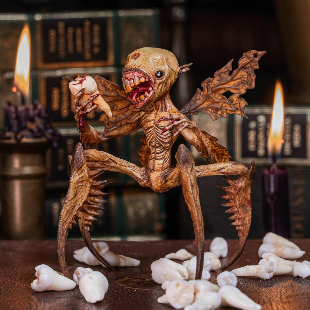 3D printed Tooth Fairy Hellboy figurine with skeletal wings, sharp claws, and a grotesque grin holding a tooth, surrounded by scattered white teeth. Hand-painted in bone, red, and brown tones, this dark fantasy collectible doubles as a tooth holder, making it perfect for gothic decor, horror props, or a unique keepsake for children’s lost teeth.